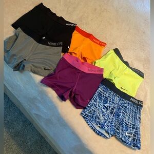 6 pairs of medium Nike Pro spandex shorts